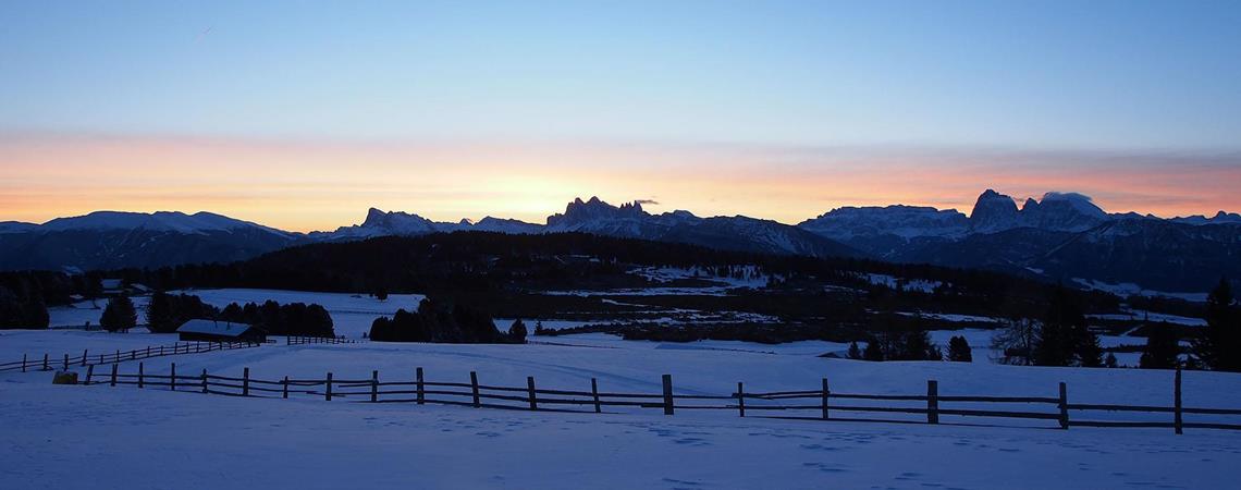 Snow-covered winter landscape at sunset
