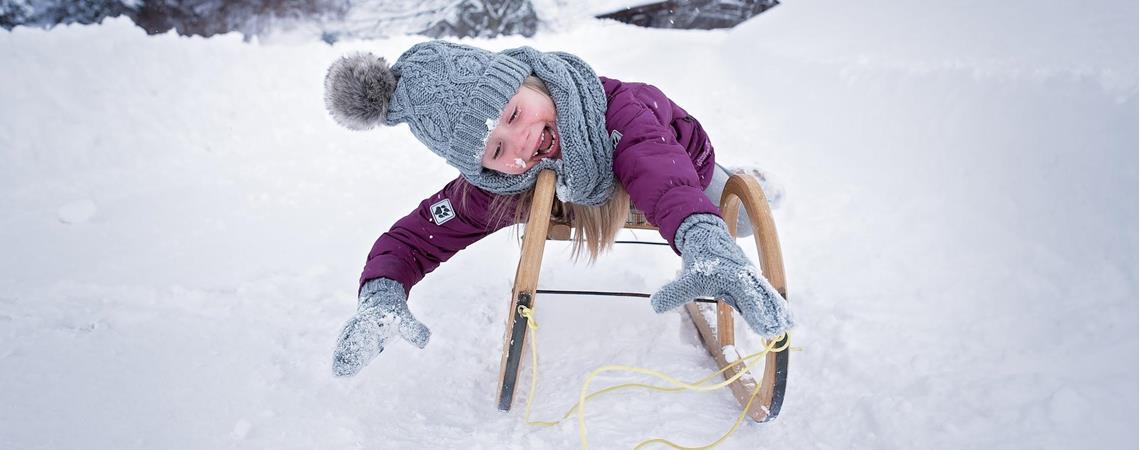 A kid on a toboggan