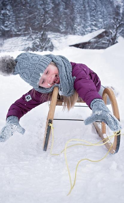A kid on a toboggan