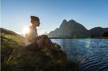 A woman at a mountain lake
